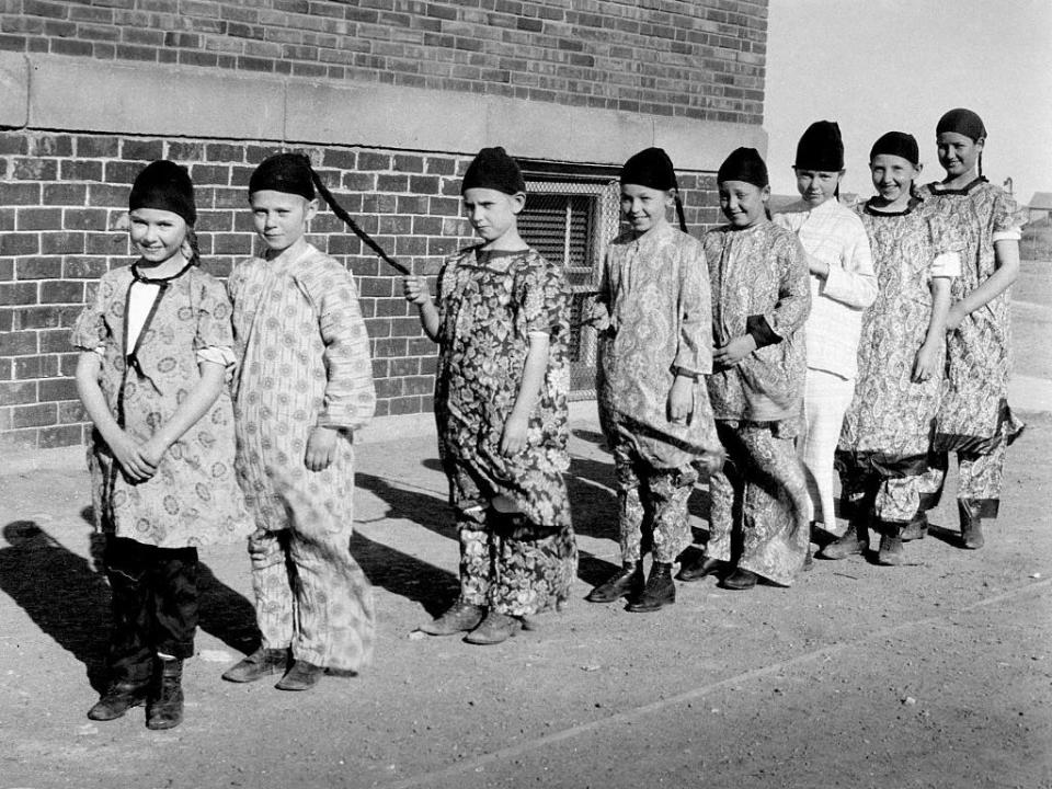 A group of children dressed up as Chinese men in 1919.