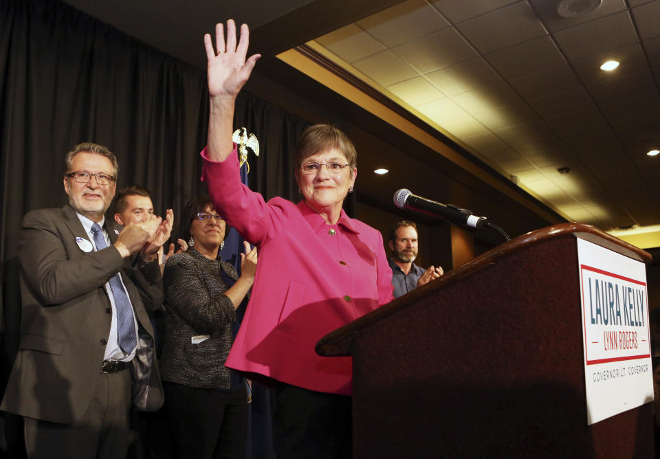 FILE - In this Nov. 6, 2018, file photo, Democrat Laura Kelly waved to the crowd at the Ramada Hotel and Convention Center in Topeka after she won election, to become the next Kansas governor. Democrats who gained new or expanded powers in state elections are gearing up for a left-leaning push on gun control, universal health care and legal marijuana. Meanwhile, some Republican legislatures that have cut taxes and limited union powers are adjusting to a new reality of needing to work with a Democratic governor. The midterm elections Tuesday, Nov. 6, increased Democratic relevance in state capitols that have been dominated by Republicans during the past decade. (Thad Allton/The Topeka Capital-Journal via AP, File)