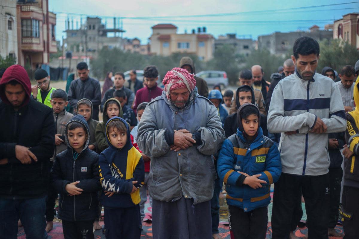 Palestinians praying during Eid al-Fitr at a refugee camp in Rafah <i>(Image: Ahmad Hasaballah/Getty Images)</i>