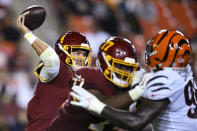 Washington Football Team quarterback Taylor Heinicke (4) throws under pressure during the first half of the team's preseason NFL football game against the Cincinnati Bengals, Friday, Aug. 20, 2021, in Landover, Md. (AP Photo/Nick Wass)