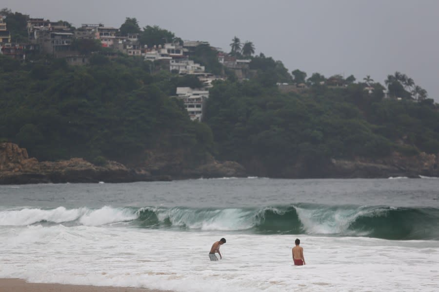 Tourists swim in Acapulco, Mexico, Tuesday, Oct. 24, 2023. Hurricane Otis has strengthened from tropical storm to a major hurricane in a matter of hours as it approaches Mexico’s southern Pacific coast where it was forecast to make landfall near the resort of Acapulco early Wednesday. (AP Photo/Bernardino Hernandez)