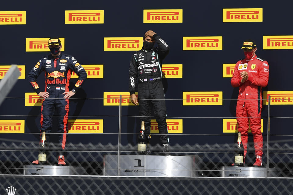 Mercedes driver Lewis Hamilton of Britain, center, celebrates his victory on the podium with second placed Red Bull driver Max Verstappen of the Netherlands, left and third placed Ferrari driver Charles Leclerc of Monaco the British Formula One Grand Prix at the Silverstone racetrack, Silverstone, England, Sunday, Aug. 2, 2020. (Ben Stansall/Pool via AP)