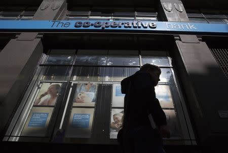 A man walks past a branch of the Co-operative bank in central London April 16, 2014. REUTERS/Neil Hall