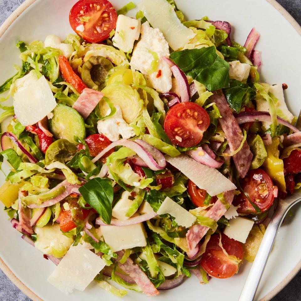 brussels sprouts salad with olives, tomatoes, red onions, shaved parmesan, and salami