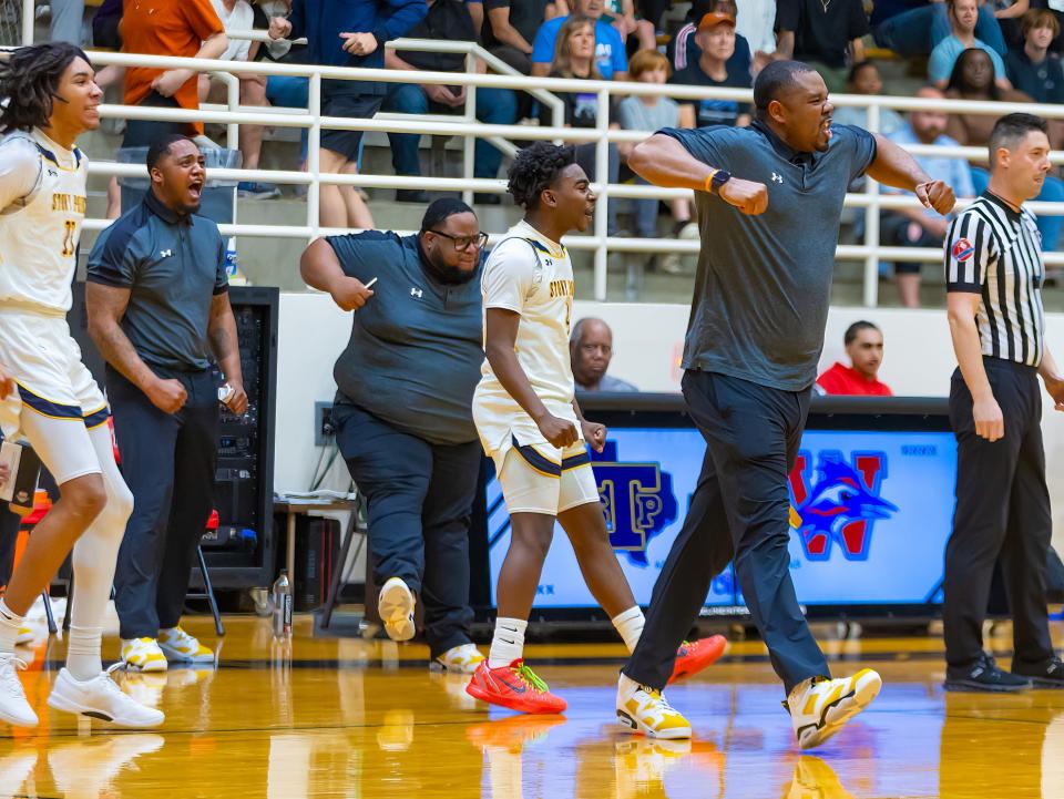 Stony Point head coach Antoine Thompson, right, and others jump off the Stony Point bench to celebrate Tuesday night's 49-35 win over Westlake in the Class 6A regional quarterfinals.