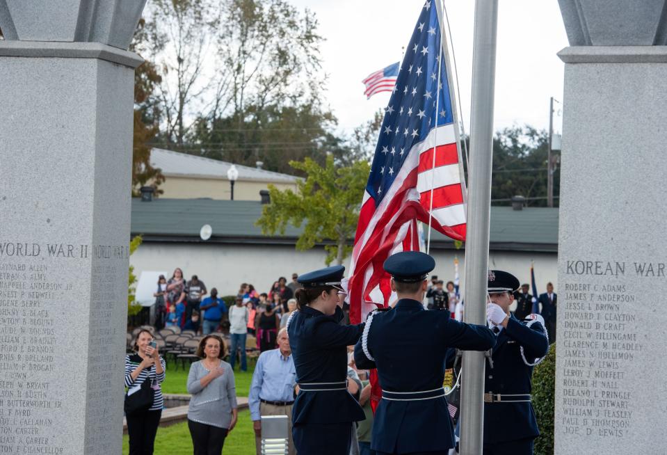 Cadets with the Southern Miss Air Force ROTC program raise a flag to half-staff during a Veterans Day ceremony at Veterans Memorial Park in Hattiesburg, Miss., on Thursday, Nov. 11, 2021.