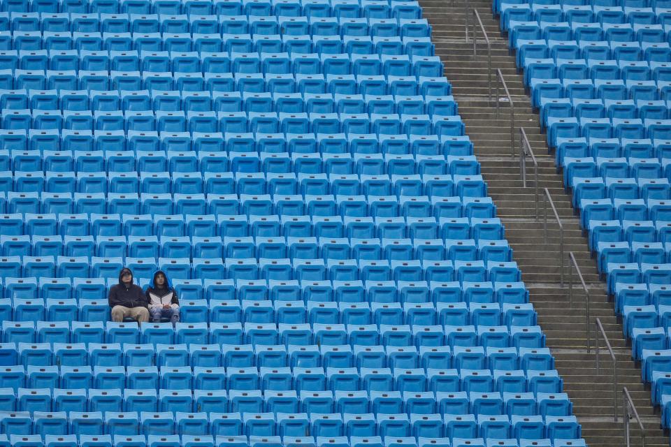 Fans sit in the rain during warm ups before the game between the Carolina Panthers and the Atlanta Falcons at Bank of America Stadium on December 17, 2023.