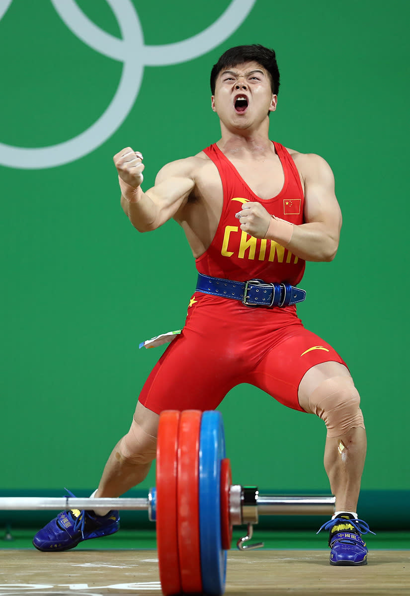 <p>Qingquan Long of China celebrates during the Men’s 56kg Group A weightlifting contest on Day 2 of the Rio 2016 Olympic Games at Riocentro – Pavilion 2 on August 7, 2016 in Rio de Janeiro, Brazil. (Photo by Lars Baron/Getty Images) </p>