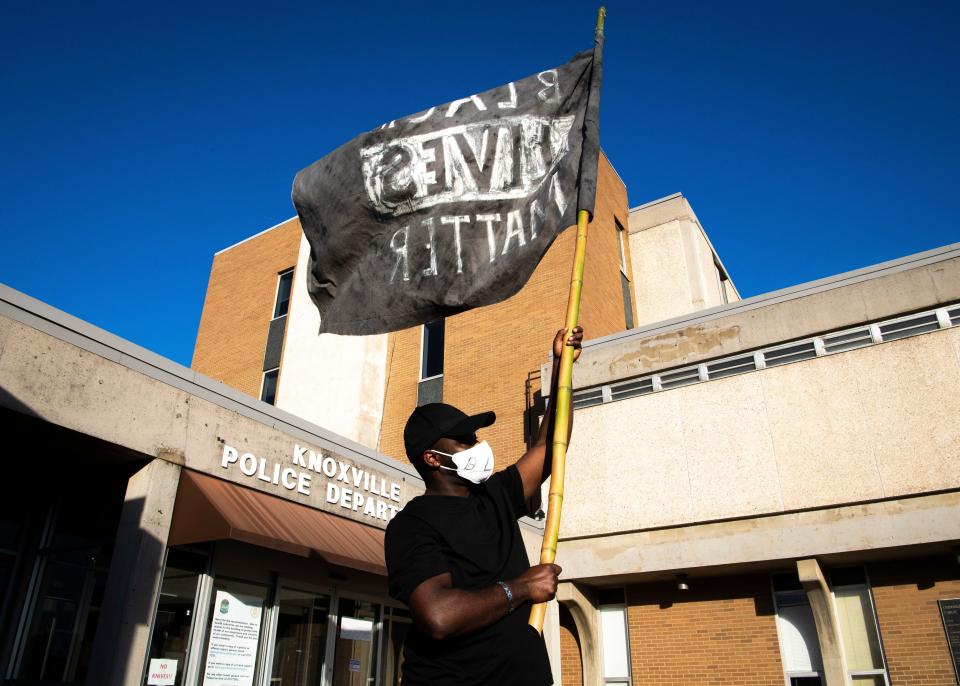 A Black Lives Matter flag is flown in front of the Knoxville Police Department headquarters May 29 in Tennessee as people gather for a rally in solidarity with Minneapolis to speak out against police brutality.