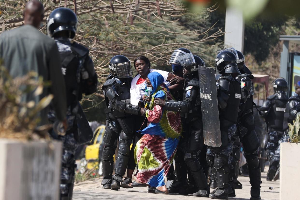 <span>Police in riot gear detain supporters of opposition candidates in Dakar on 4 February, the day after the announcement postponing the presidential election.</span><span>Photograph: Anadolu/Getty Images</span>