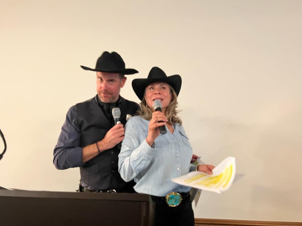 Adam Voss and Jan Harnik oversee the live auction at the Family YMCA of the Desert's 35th annual Hoedown at Sundown.
