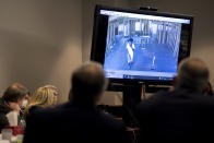 Prosecutor Linda Dunikoski shows a video of Ahmaud Arbery walking through a house under construction during the trial of Greg McMichael and his son, Travis McMichael, and a neighbor, William "Roddie" Bryan in the Glynn County Courthouse, Tuesday, Nov. 9, 2021, in Brunswick, Ga. The three are charged with the February 2020 slaying of 25-year-old Ahmaud Arbery. (AP Photo/Stephen B. Morton, Pool)