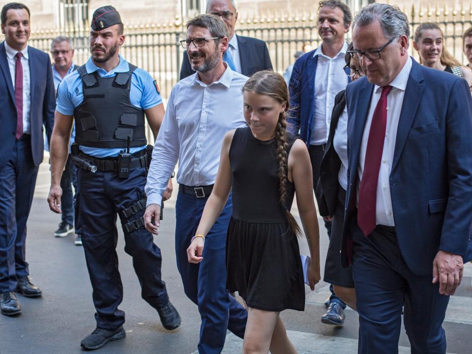 Swedish climate activist Greta Thunberg, centre, arrives for a meeting in the French National Assembly, in Paris, France, Tuesdays, July 23, 2019. (AP Photo/Rafael Yaghobzadeh )