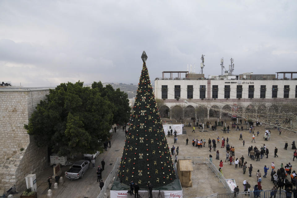 People gather in Manger Square, adjacent to the Church of the Nativity, traditionally believed to be the birthplace of Jesus Christ, in the West Bank town of Bethlehem, Saturday, Dec. 24, 2022. (AP Photo/Mahmoud Illean)