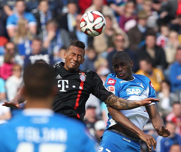 Hoffenheim's French forward Anthony Modeste (R) and Bayern Munich's defender Jerome Boateng vie for the ball during their German first division Bundesliga football match in Sinsheim, southern Germany, on April 18, 2015