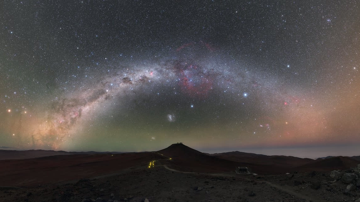  The milky way arched over a dark landscape. 