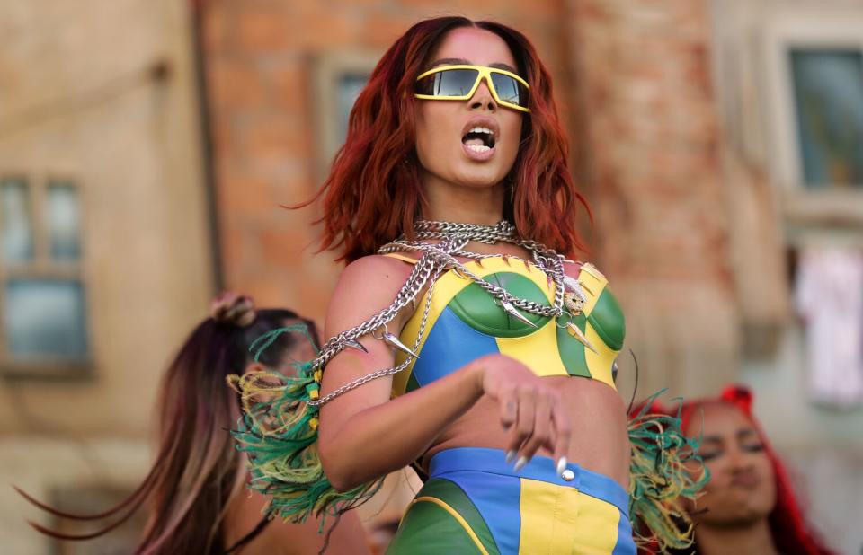 A female singer performs onstage.