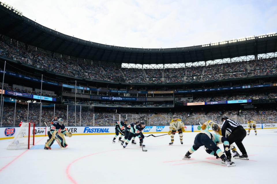 Jan 1, 2024; Seattle, Washington, USA; Seattle Kraken left wing Jared McCann (19) and Vegas Golden Knights center Ivan Barbashev (49) face-off during the first period in the 2024 Winter Classic ice hockey game at T-Mobile Park. Mandatory Credit: Steven Bisig-USA TODAY Sports