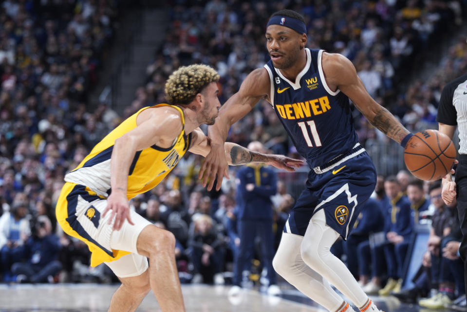 Denver Nuggets forward Bruce Brown is defended by Indiana Pacers guard Chris Duarte during the second half of an NBA basketball game Friday, Jan. 20, 2023, in Denver. (AP Photo/David Zalubowski)