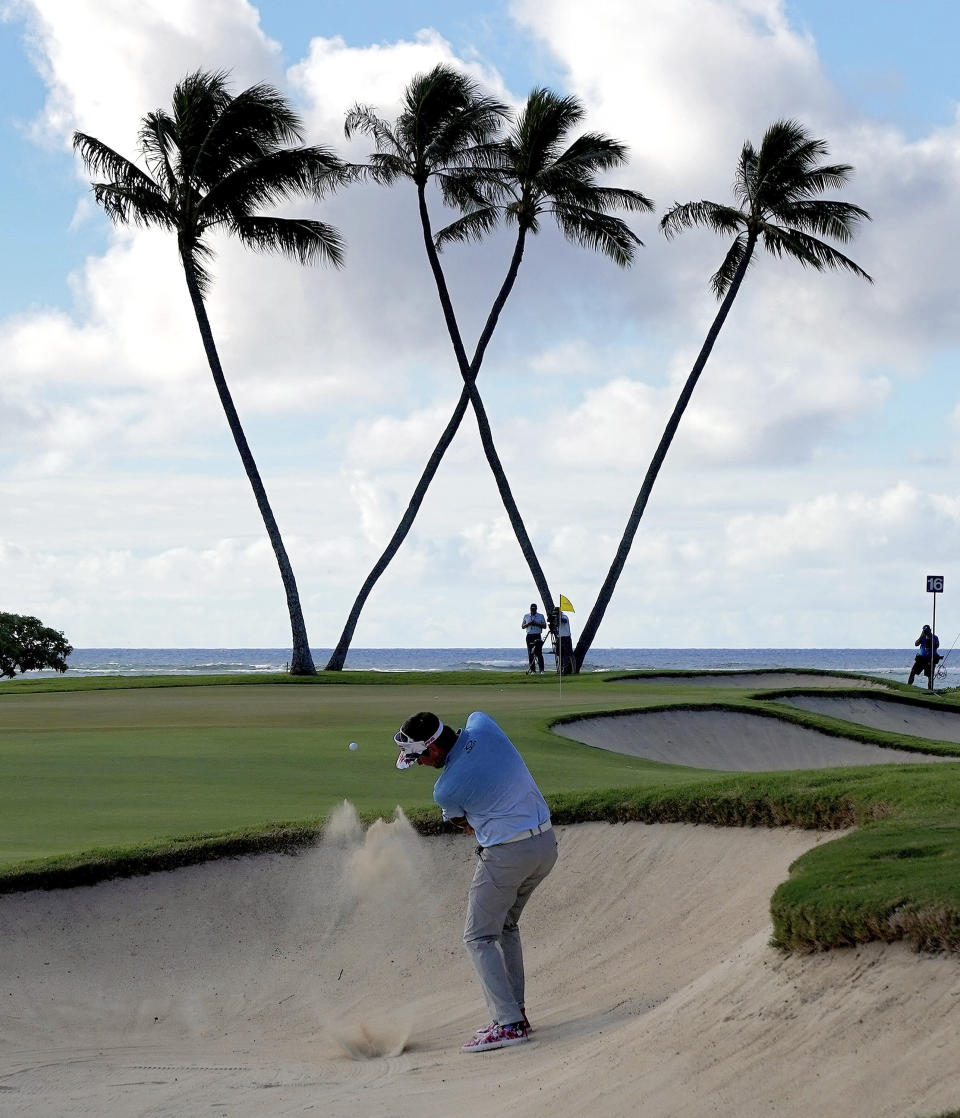 Bubba Watson hits out of the bunker on the 16th green during the first round of the Sony Open PGA Tour golf event, Thursday, Jan. 10, 2019, at the Waialae Country Club in Honolulu, Hawaii. (AP Photo/Matt York)