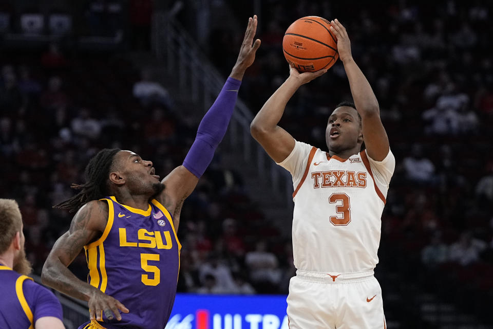 Texas guard Max Abmas (3) shoots over LSU forward Mwani Wilkinson (5) during the first half of an NCAA college basketball game, Saturday, Dec. 16, 2023, in Houston. (AP Photo/Kevin M. Cox)