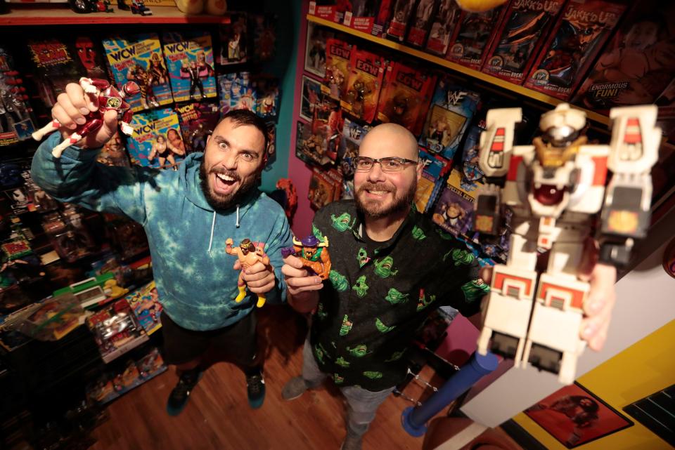 When not in the ring, local wrestler Ted Bolduc, left, co-owns Cojo's Toy World on Purchase Street in New Bedford with his cousin Jason Aguiar.