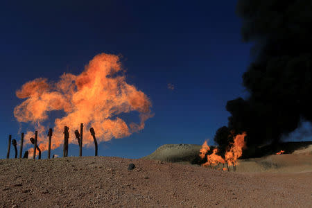 FILE PHOTO: Flames emerge from flare stacks at the oil fields in Dibis area on the outskirts of Kirkuk, Iraq October 17, 2017. REUTERS/Alaa Al-Marjani/File Photo