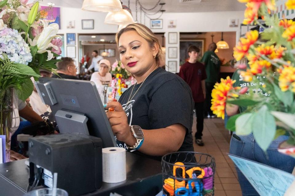 Naz Begum, one of the new owners of Sammy’s Restaurant in North Sacramento, works the register during the grand reopening celebration on Friday. “This has been a dream come true,” Begum said. “I’ve been waiting for this day for 20 years.”