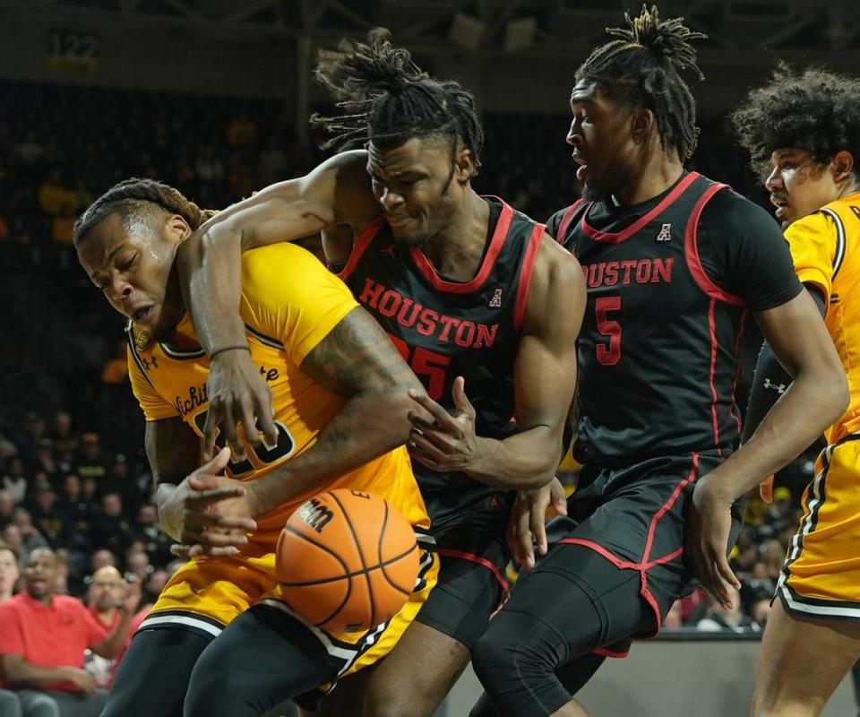 Wichita State University’s Gus Okafor and Houston’s Jarace Walker scramble for the ball in the first half against the University of Houston during their game at Koch Arena.