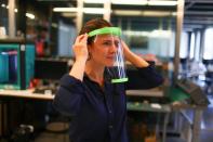 A technical staff tests a 3D printed protective visor made for healthcare professionals, amid the coronavirus disease (COVID-19) outbreak, at the Casa Firjan FabLab in Rio de Janeiro