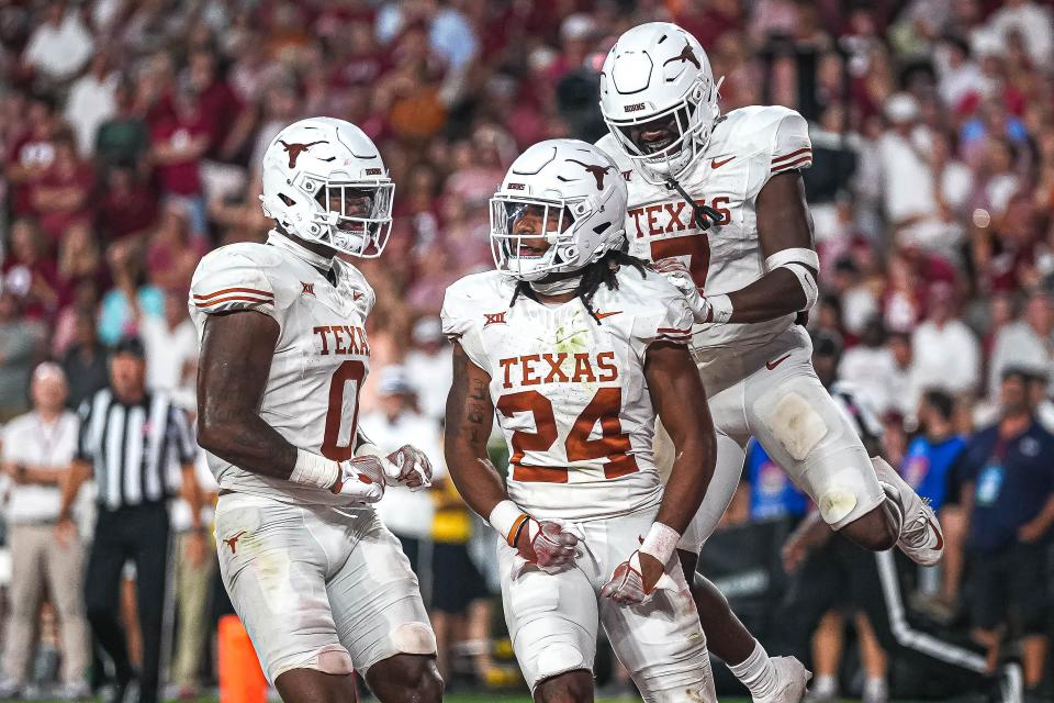 Texas running back Jonathon Brooks, center, wanted to wear his high school number, 25, when he arrived at Texas. But 25 wasn't available, and so he ended up with 24. Hallettsville High School has retired Brooks' old No. 25.