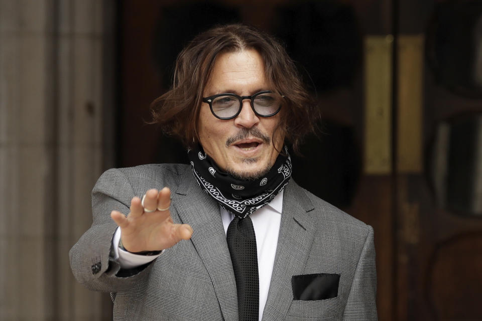 American actor Johnny Depp gestures to the media as he arrives at the High Court in London, Monday, July 13, 2020. Depp is expected to wrap up his evidence at his libel trial against a tabloid newspaper that accused him of abusing ex-wife Amber Heard. The Hollywood star is suing News Group Newspapers, publisher of The Sun, and the paper’s executive editor, Dan Wootton, over an April 2018 article that called him a “wife-beater.” (AP Photo/Matt Dunham)