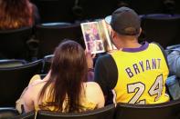 A person wears a Lakers Kobe Bryant #24 jersey during a public memorial for NBA great Kobe Bryant, his daughter Gianna and seven others killed in a helicopter crash on January 26, at the Staples Center in Los Angeles