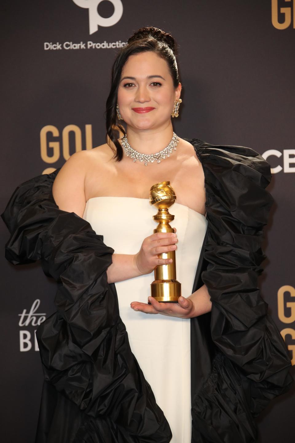 "Killers of the Flower Moon" star Lily Gladstone poses with her Golden Globe Award.