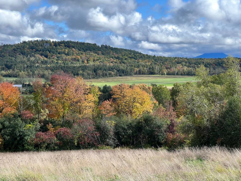 The view from Oak Hill Road in Williston on Oct. 8, 2023 shows near peak fall color and Camel's Hump partially shrouded in clouds in the background.