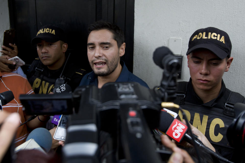 Matias Ponce, spokesman of the United Nations International Commission Against Impunity, CICIG, speaks to reporters, surrounded by police agents, at the CICIG headquarters in Guatemala City, Country, Friday, Aug. 31, 2018. Guatemala president Jimmy Morales says he is not renewing mandate of U.N.-sponsored commission investigating corruption in the country. (AP Photo/Moises Castillo)