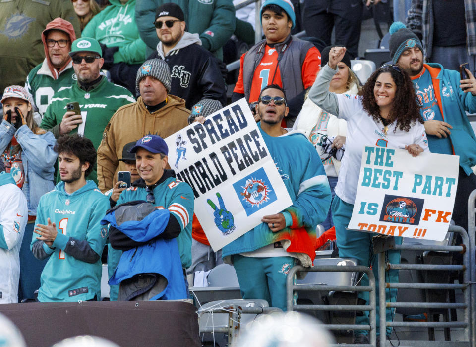 Miami Dolphins fans show their support during warmups before the start of an NFL football game against the New York Jets, Friday, Nov. 24, 2023, in East Rutherford, N.J. (David Santiago/Miami Herald via AP)