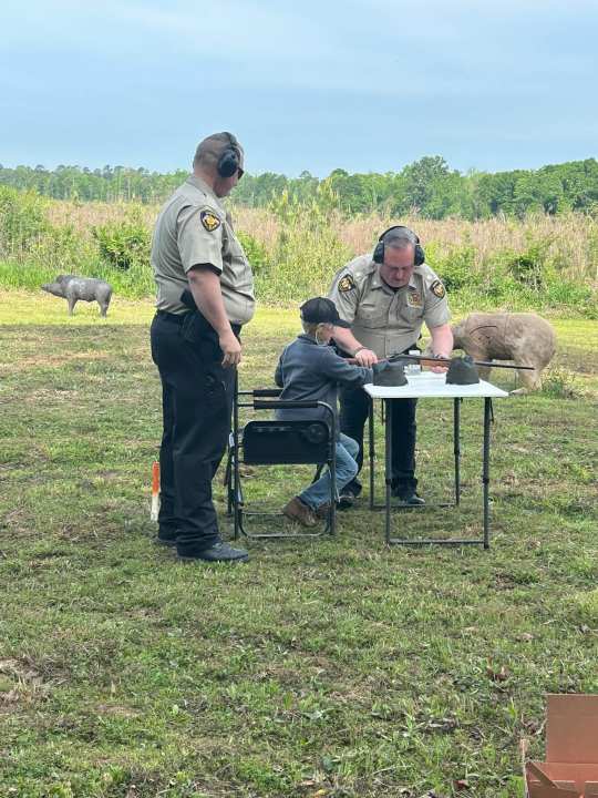 Members of Panola County Sheriff’s Office teaches a child about shotgun safety. Photo courtesy of Panola County Sheriff’s Office.