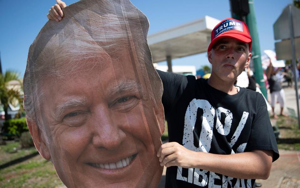 Supporters of former President Donald Trump gather along Southern Blvd near Trump's Mar-a-Lago home on Feb 15, 2021 - Joe Raedle/Getty Images North America 