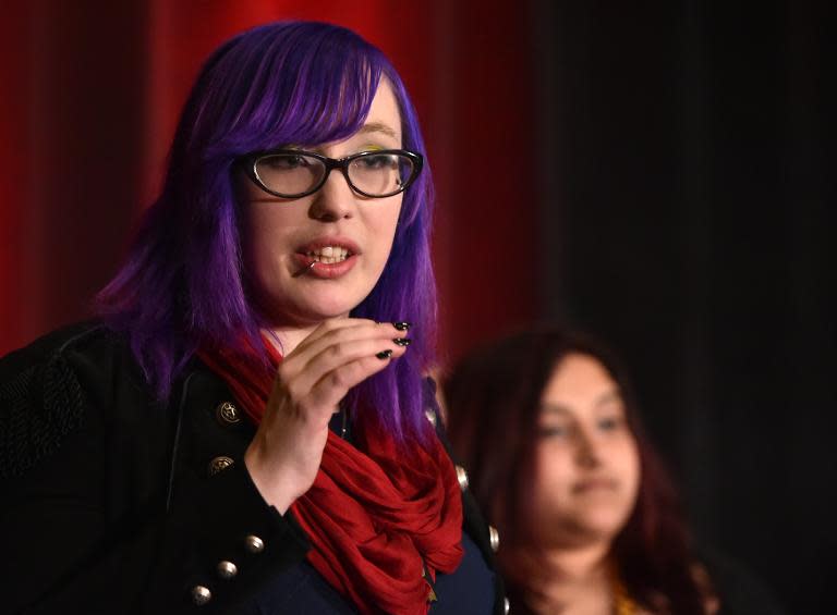 Independent game developer Zoe Quinn, speaking at the Game Developers Conference in San Francisco on March 4, 2015, is at the center of a fierce debate regarding sexism and racism in video games and the male-dominated industry that makes them