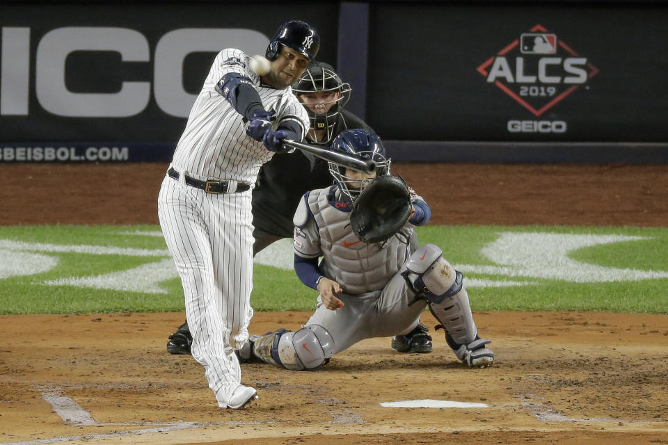 FILE - In this Oct. 18, 2019, file photo, New York Yankees' Aaron Hicks connects for a three-run home run against the Houston Astros during the first inning of Game 5 of baseball's American League Championship Series, in New York. Yankees general manager Brian Cashman is optimistic Aaron Judge, James Paxton, Aaron Hicks and Giancarlo Stanton will be ready to play in time for New York's rescheduled opener at World Series champion Washington on July 23.(AP Photo/Seth Wenig, File)