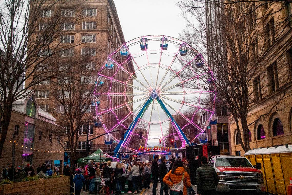 A ferris wheel towers over Fayetteville Street during the Carolina Hurricanes Fan Fest 2023, a free, all-day party in downtown Raleigh Friday, Feb. 17, 2023.