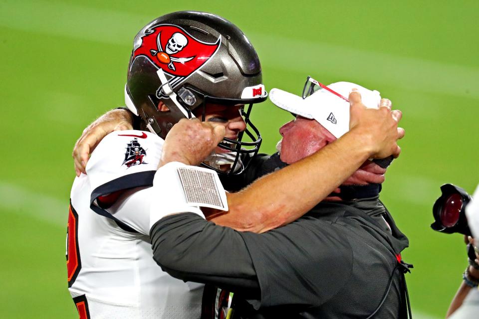 Tampa Bay Buccaneers quarterback Tom Brady and head coach Bruce Arians celebrate during the fourth quarter of Super Bowl 55.