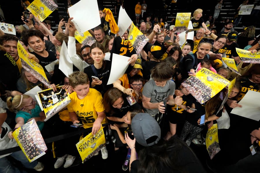 Iowa guard Caitlin Clark signs autographs during an Iowa women’s basketball team celebration, Wednesday, April 10, 2024, in Iowa City, Iowa. Iowa lost to South Carolina in the Final Four college basketball championship game of the women’s NCAA Tournament on Sunday. (AP Photo/Charlie Neibergall)