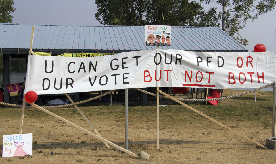 Signs urging Alaska lawmakers to fund a full oil wealth fund check, known locally as the PFD or Permanent Fund Dividend, are shown Monday, July 8, 2019, in Wasilla, Alaska. Some Alaska lawmakers are meeting in Wasilla July 8 instead of Juneau, where state House and Senate leadership have decided to hold the special session. (AP Photo/Mark Thiessen)