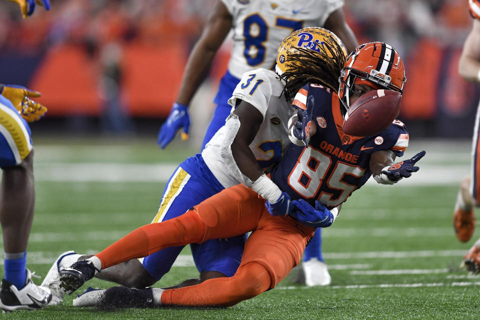 Syracuse wide receiver Courtney Jackson (85) makes a juggling catch while covered by Pittsburgh defensive back Erick Hallett II (31) during the first half of an NCAA college football game in Syracuse, N.Y., Saturday, Nov. 27, 2021. (AP Photo/Adrian Kraus)