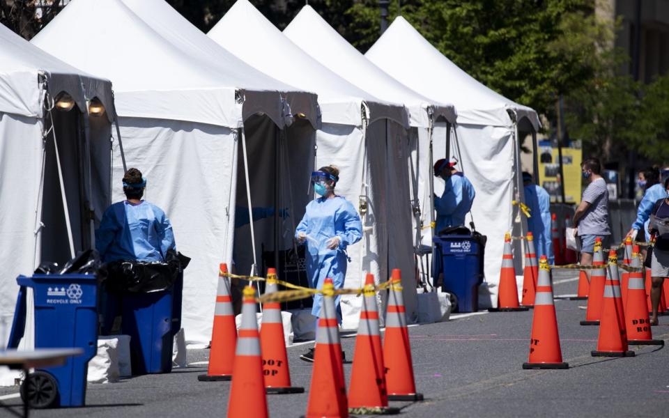 Medical Reserve Corps volunteers, nurses and District of Columbia Department of Health officials operate a walk-up COVID-19 testing site in Washington, DC - MICHAEL REYNOLDS/EPA-EFE/Shutterstock/Shutterstock