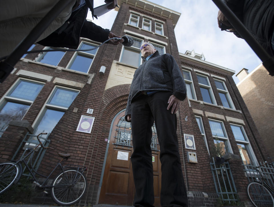 Theo Hettema, chair of the General Council of the Protestant Church of The Hague, answers questions during an interview in front of the Bethel church in The Hague, Netherlands, Friday, Nov. 30, 2018. For more than a month, a rotating roster of preachers and visitors has been leading a non-stop, round-the-clock service at a small Protestant chapel in a quiet residential street in The Hague in an attempt to prevent the deportation of a family of Armenian asylum seekers. (AP Photo/Peter Dejong)