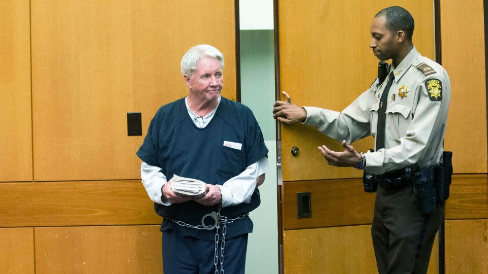 Claud "Tex" McIver enters the courtroom holding a bible filled with papers before his sentencing at the Fulton County courthouse in Atlanta in May 2018. - Alyssa Pointer/Pool/Atlanta Journal-Constitution/AP