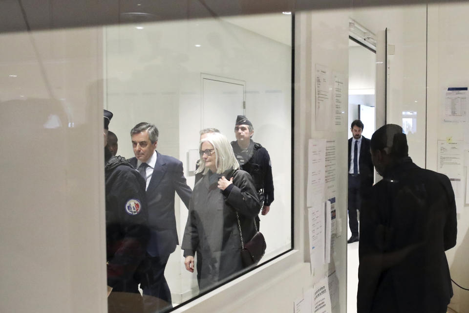 France's former Prime Minister Francois Fillon, right, and his wife Penelope, arrive at the Paris courthouse, in Paris, Wednesday, Feb. 26, 2020. He could have been president of France. Instead, former Prime Minister Francois Fillon is going on trial to face fraud charges after he used public funds to richly pay his wife and children for work they allegedly never performed. (AP Photo/Thibault Camus)